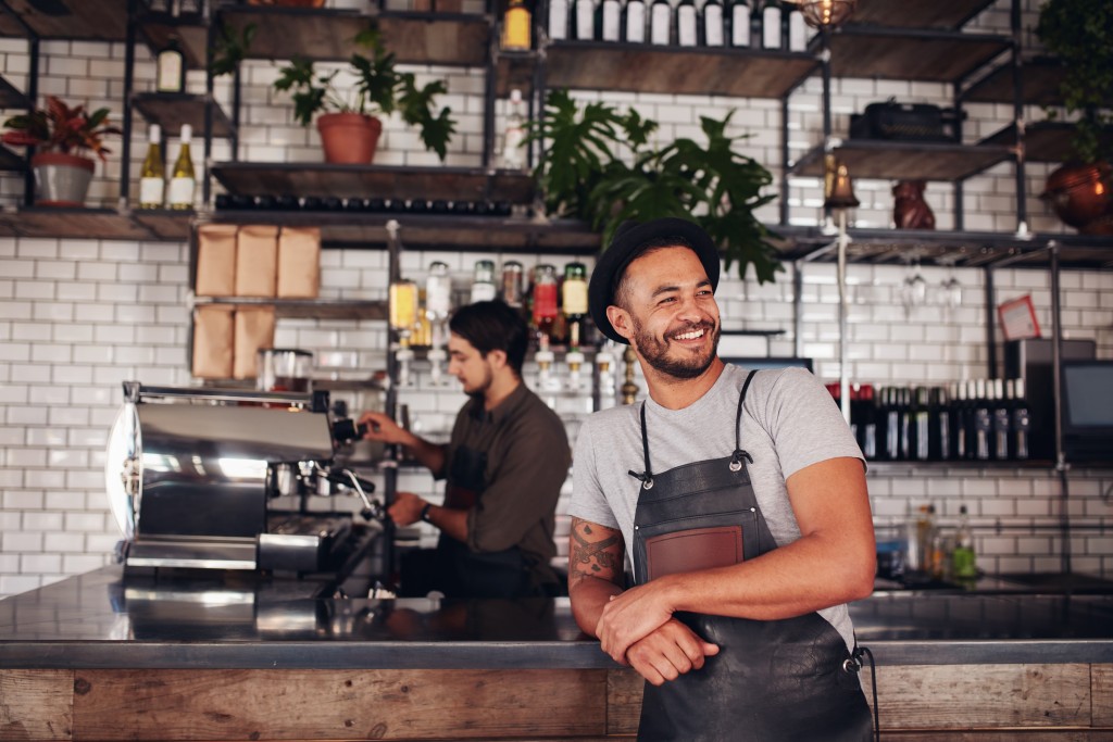 Cafe owner leaning against the counter