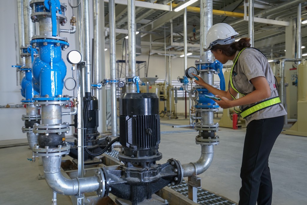 an engineer checking the pumps' voltage