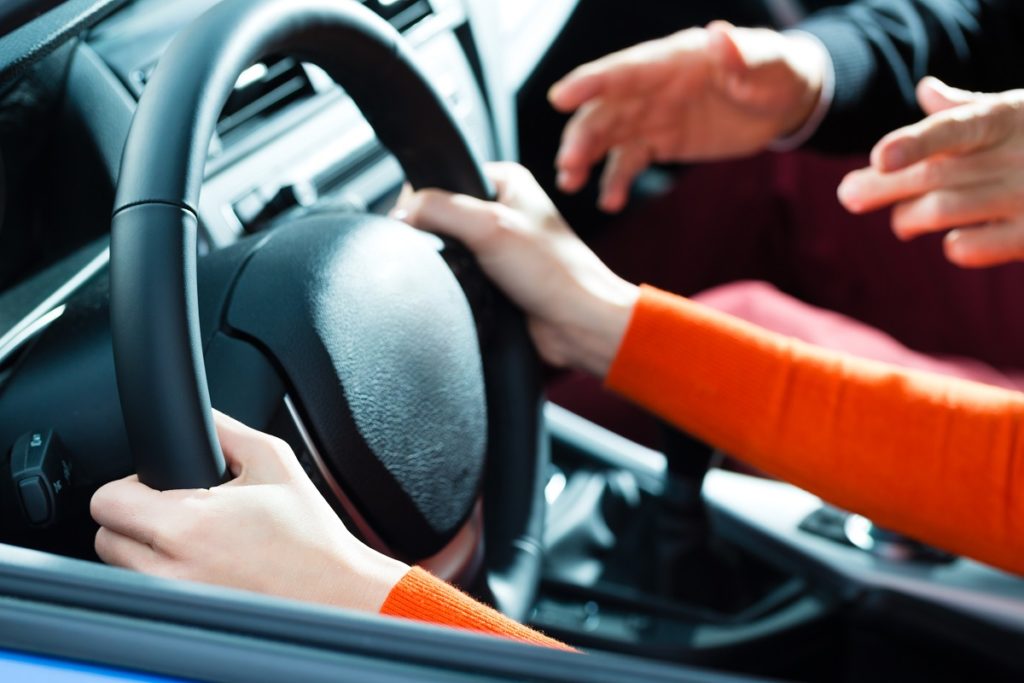 woman being taught how to drive