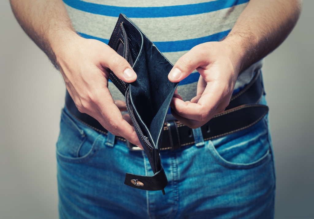 a man holding an empty wallet